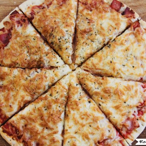 Air Fryer Oven Frozen Pizza sliced with extra cheese