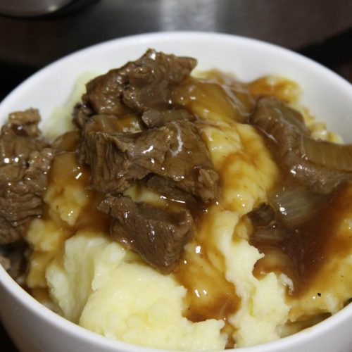 Instant Pot Beef Tips And Gravy Over Mashed Potatoes