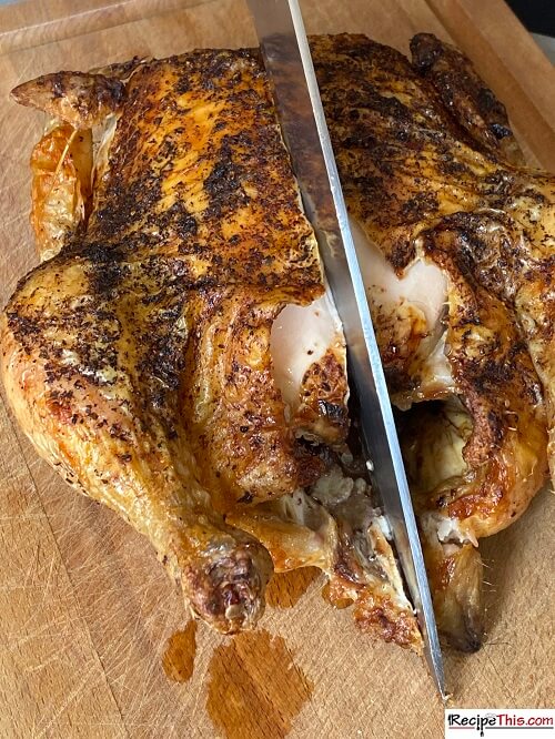 chopping piri piri whole chicken down the middle